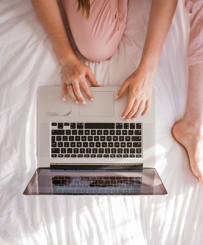 Overhead view of a person typing on a laptop