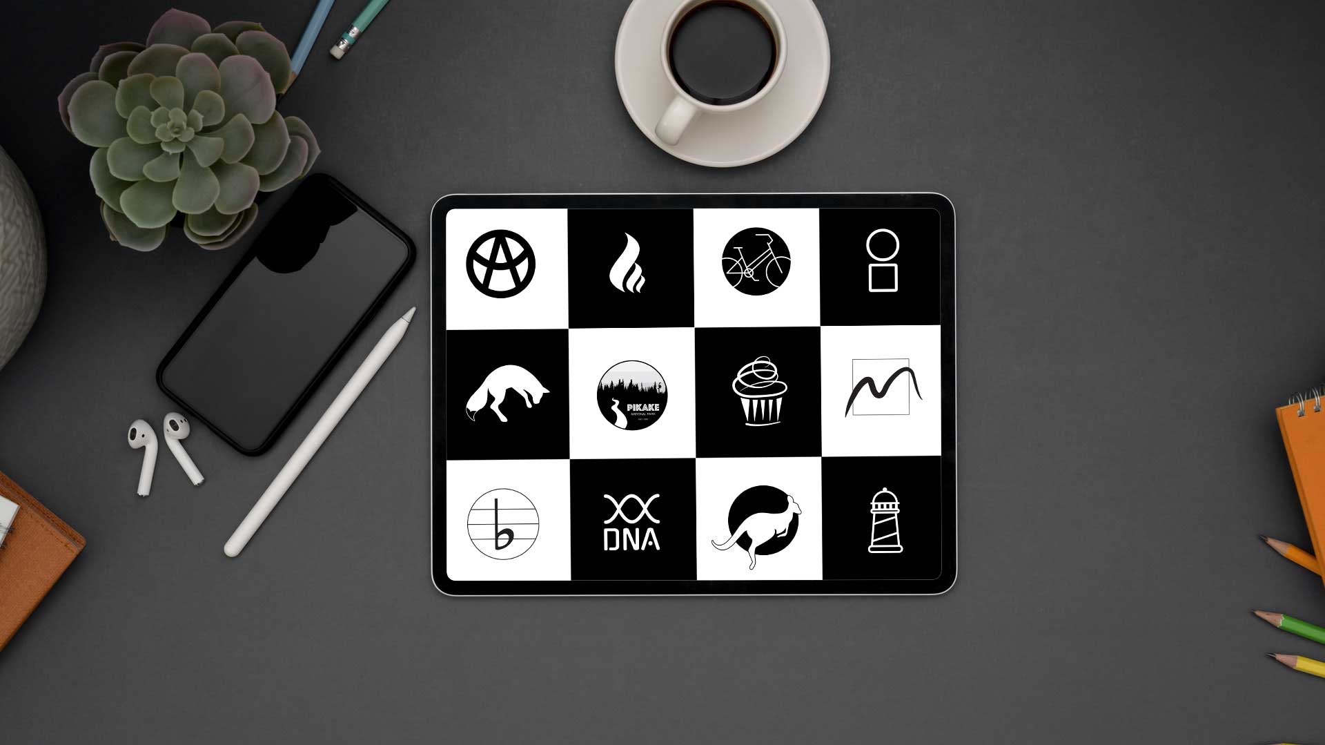 Tablet on a tabletop displaying logo designs